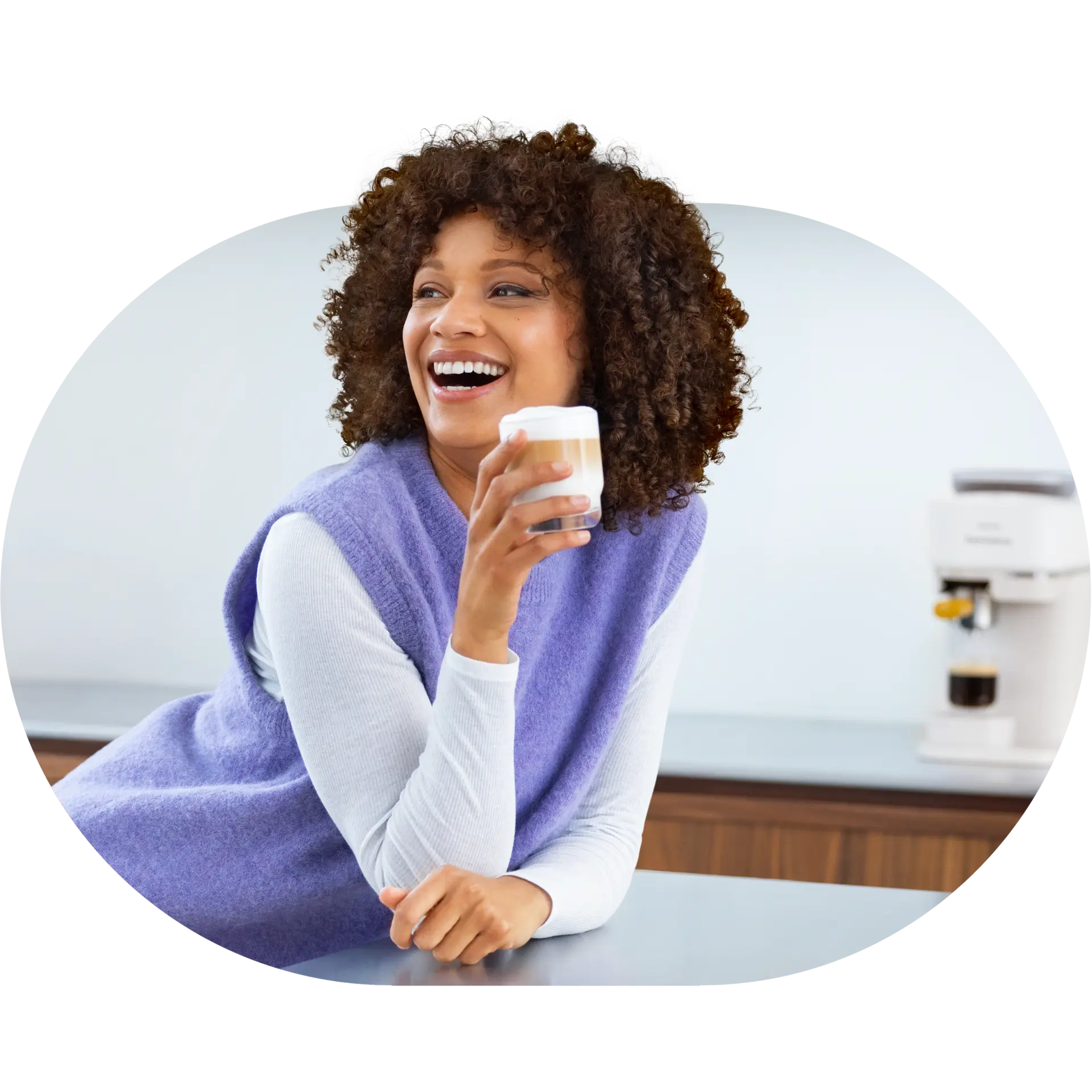 Smiling woman holds a Philips Baristina espresso. She looks happy and content, enjoying her drink. Smiling woman holds a Philips Baristina espresso. She looks happy and content, enjoying her drink.