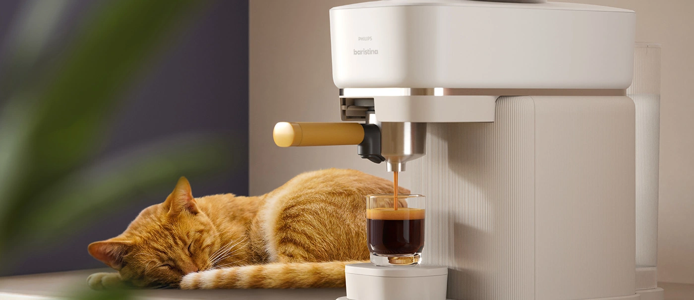 Chat dormant à côté de la machine à expresso Baristina en train de faire un café Chat dormant à côté de la machine à expresso Baristina en train de faire un café